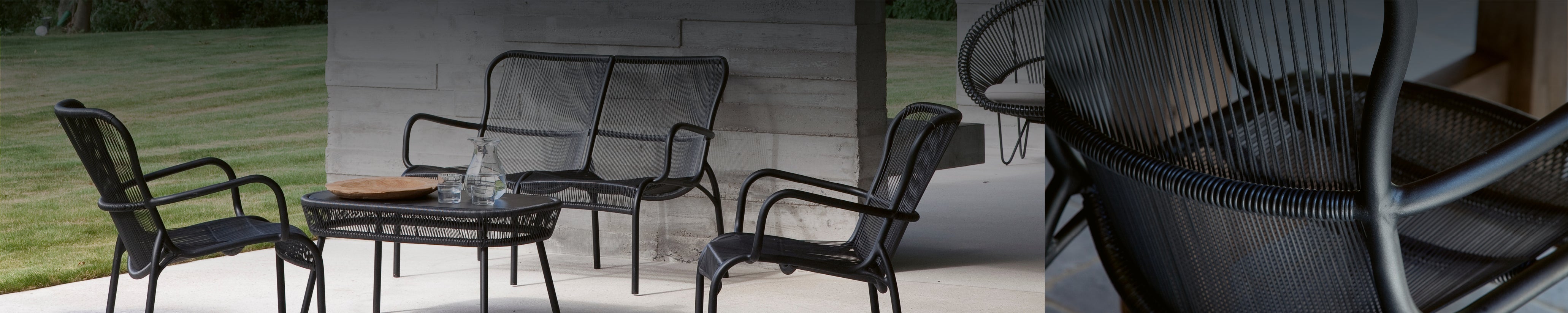 Vincent Sheppard Loop Loungegruppe mit filigranen Geflechtmöbeln auf Terrasse mit Betonpfeilern