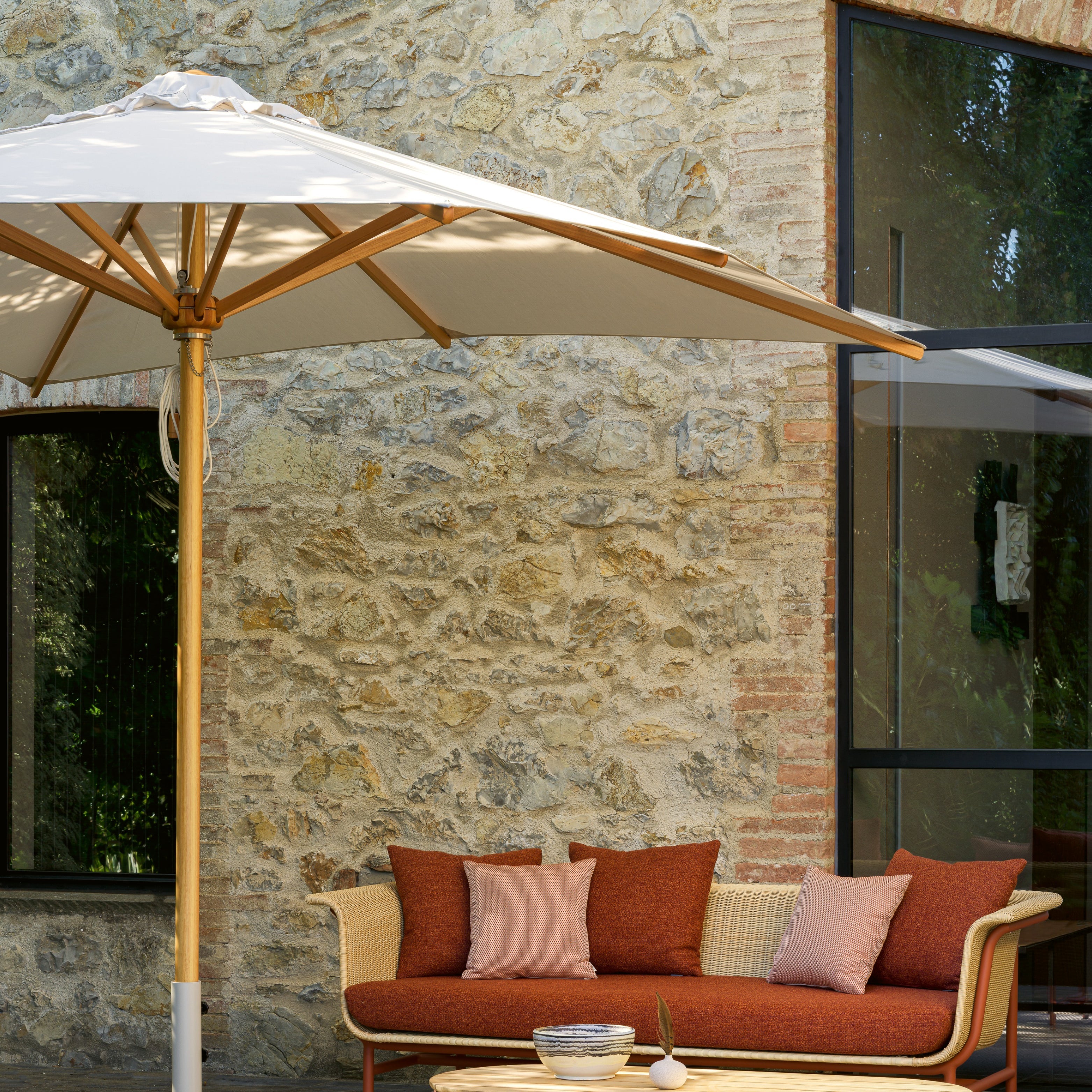 Sonnen- und Schattensituation mit Sonnenschirm und Outdoor-Sofa für Terrasse und Garten