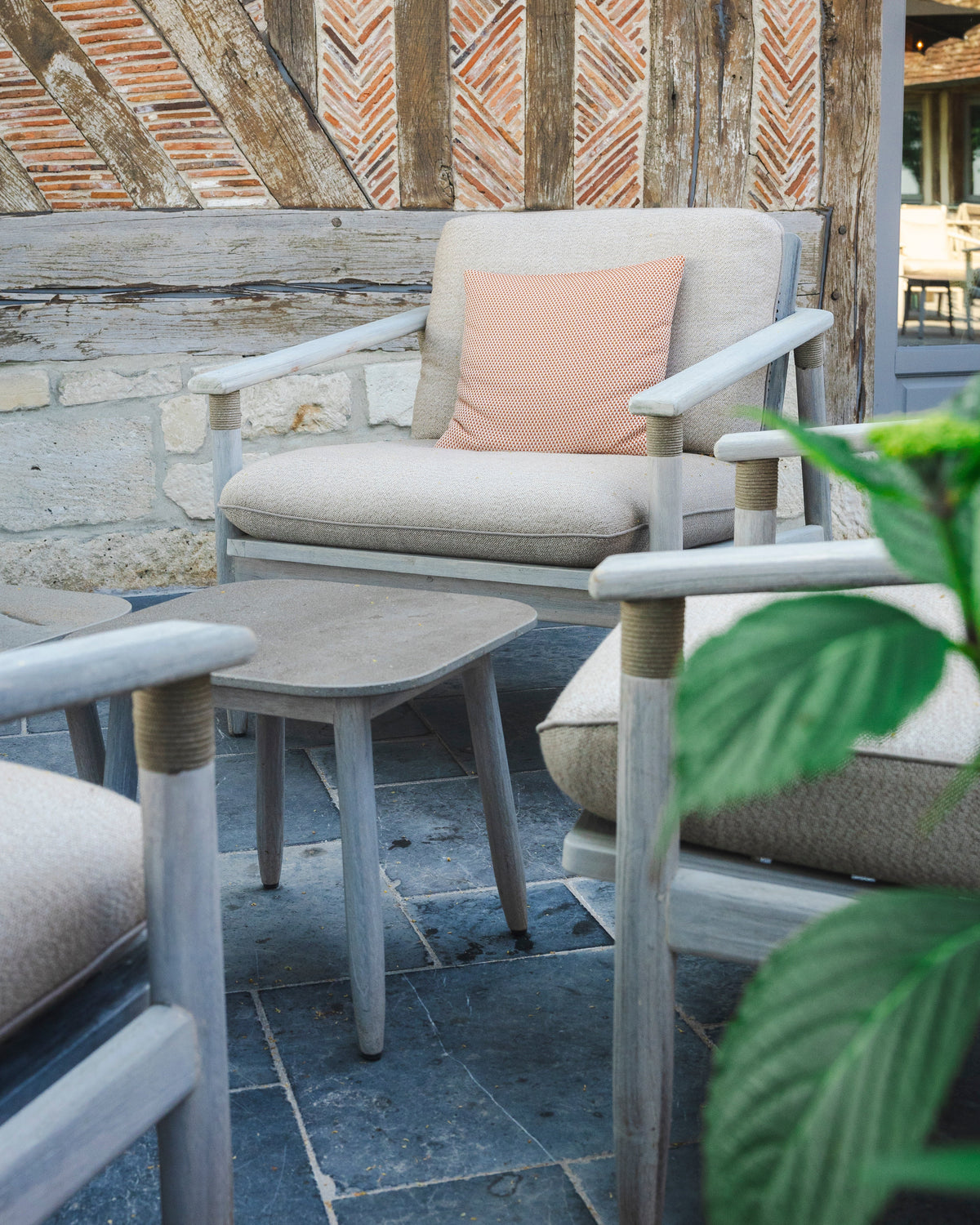 Vincent Sheppard DAVID Beistelltisch neben einem Loungesessel auf der Terrasse