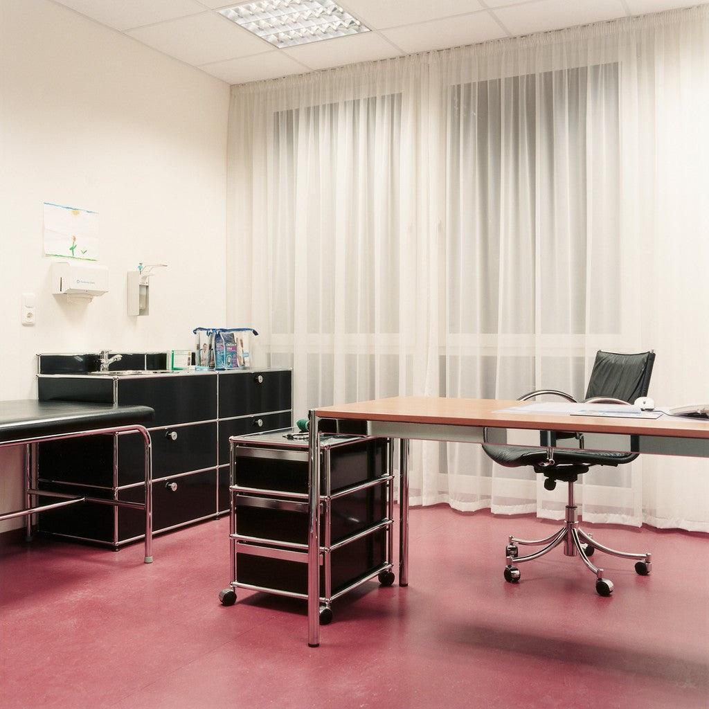 USM Rollcontainer M26 in tiefem Graphitschwarz – hochwertiges Designmöbel als stilvolle Ergänzung im Chefzimmer oder Besprechungsraum, mit Fokus auf klare Linien und Funktionalität